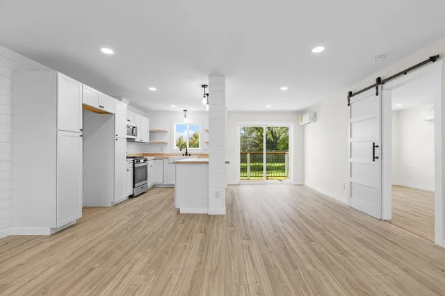 a view of a kitchen with a sink and wooden floor