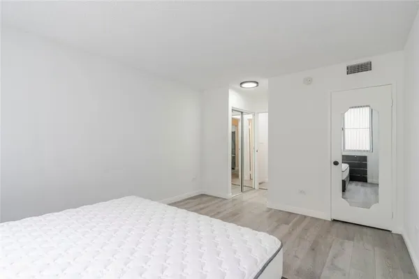 a bathroom with a sink a toilet a mirror and shower