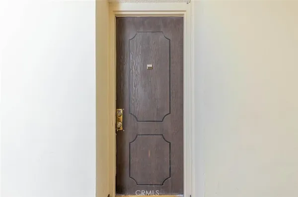 an empty room with furniture wooden floor fireplace and windows