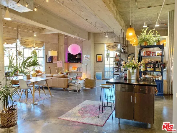 a living room with lots of furniture and kitchen view