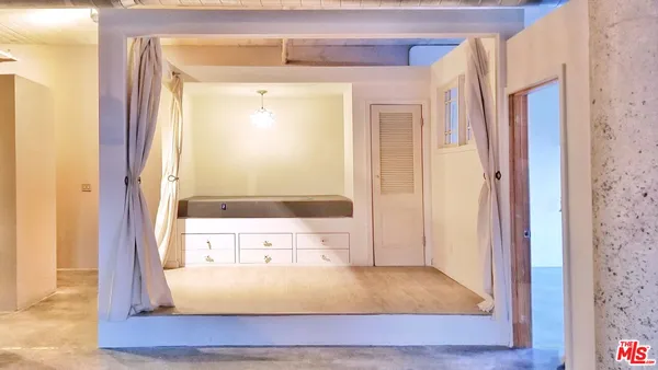 a bedroom with a bed and a large window