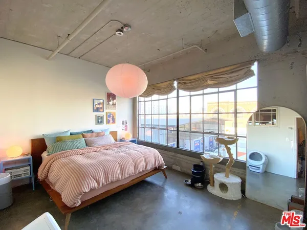 a bedroom with a bed and window