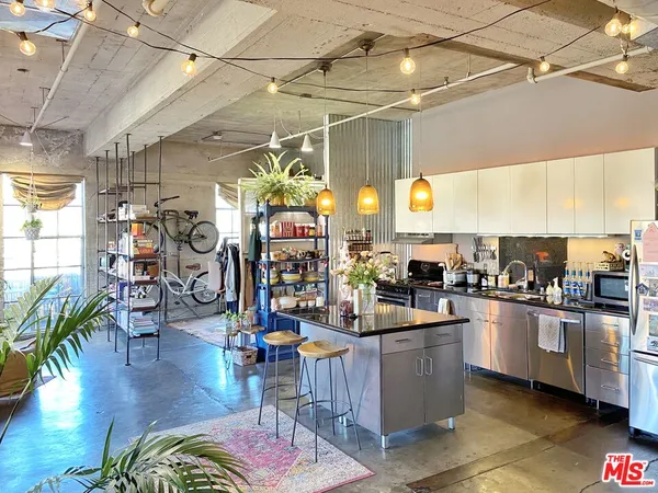 a kitchen with lots of counter top space and wooden floor