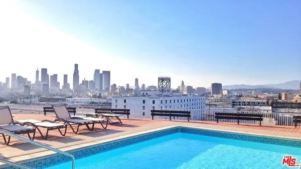 a view of swimming pool with outdoor seating and yard in back