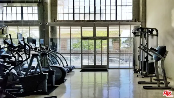 a room with gym equipment and view of living room