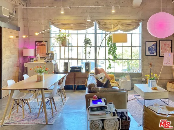 a living room with furniture a rug and a large window