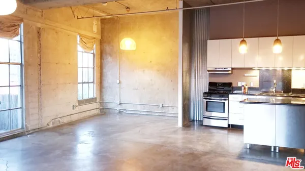 a view of a kitchen with a sink and cabinets