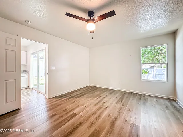 wooden floor in an empty room with a window