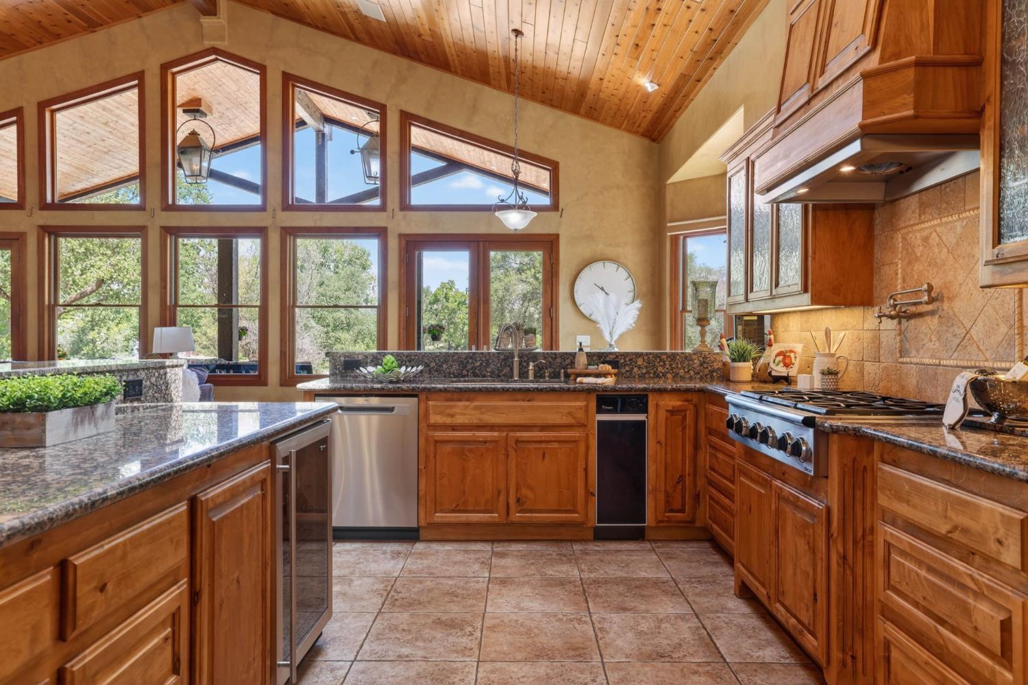 7021 Horseshoe Bar Road Loomis, CA 95650 - Photo 11 of 77 a large kitchen with stainless steel appliances granite countertop a stove a sink and a granite counter tops