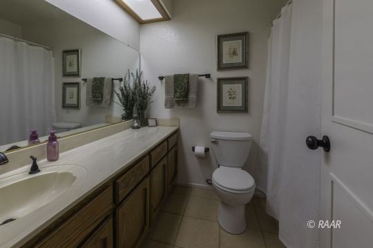 815 James Street Ridgecrest, CA 93555 - Photo 15 of 27 a bathroom with a granite countertop toilet sink and mirror