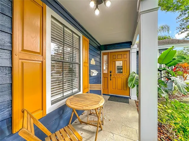 a large kitchen with kitchen island a dining table chairs and a wooden floor