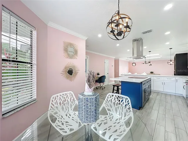 a bedroom with furniture and a large window