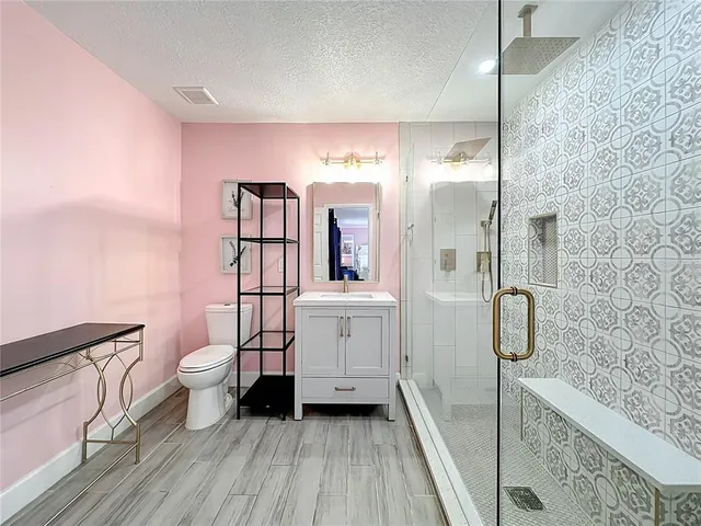 a bathroom with a toilet sink and mirror