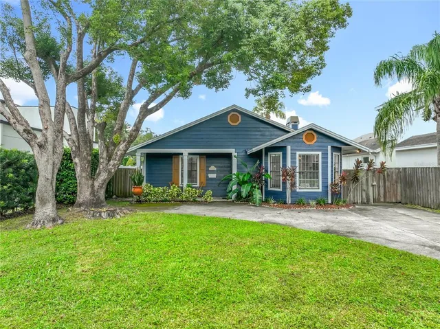a front view of a house with a garden and plants