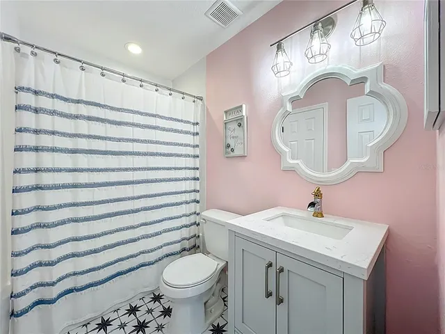 an aerial view of a house with a yard and lake view