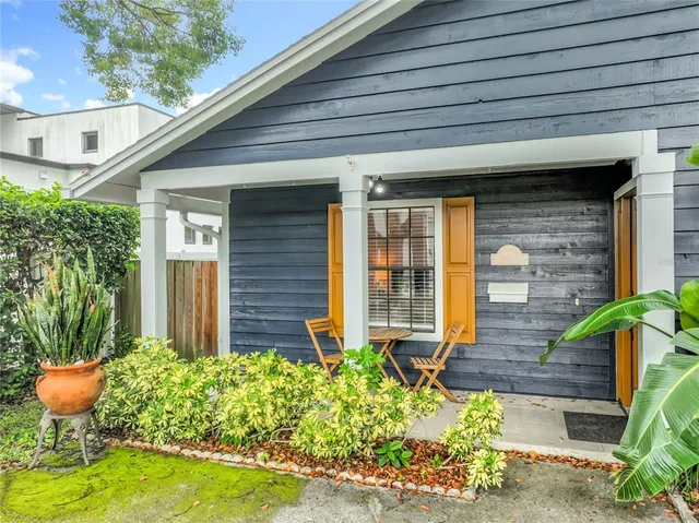 a front view of a house with porch and outdoor seating