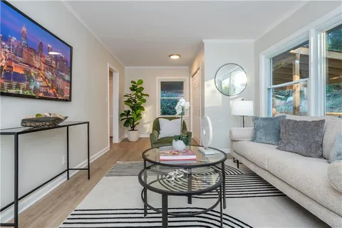 a living room with furniture and a dining table