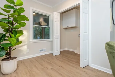 a view of empty room with wooden floor