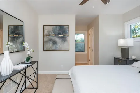 a bedroom with a bed and a mirror