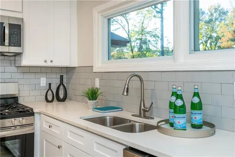 a kitchen with appliances cabinets and a window