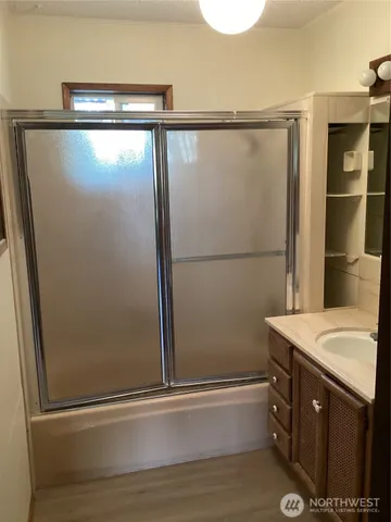 a bathroom with a shower and a sink