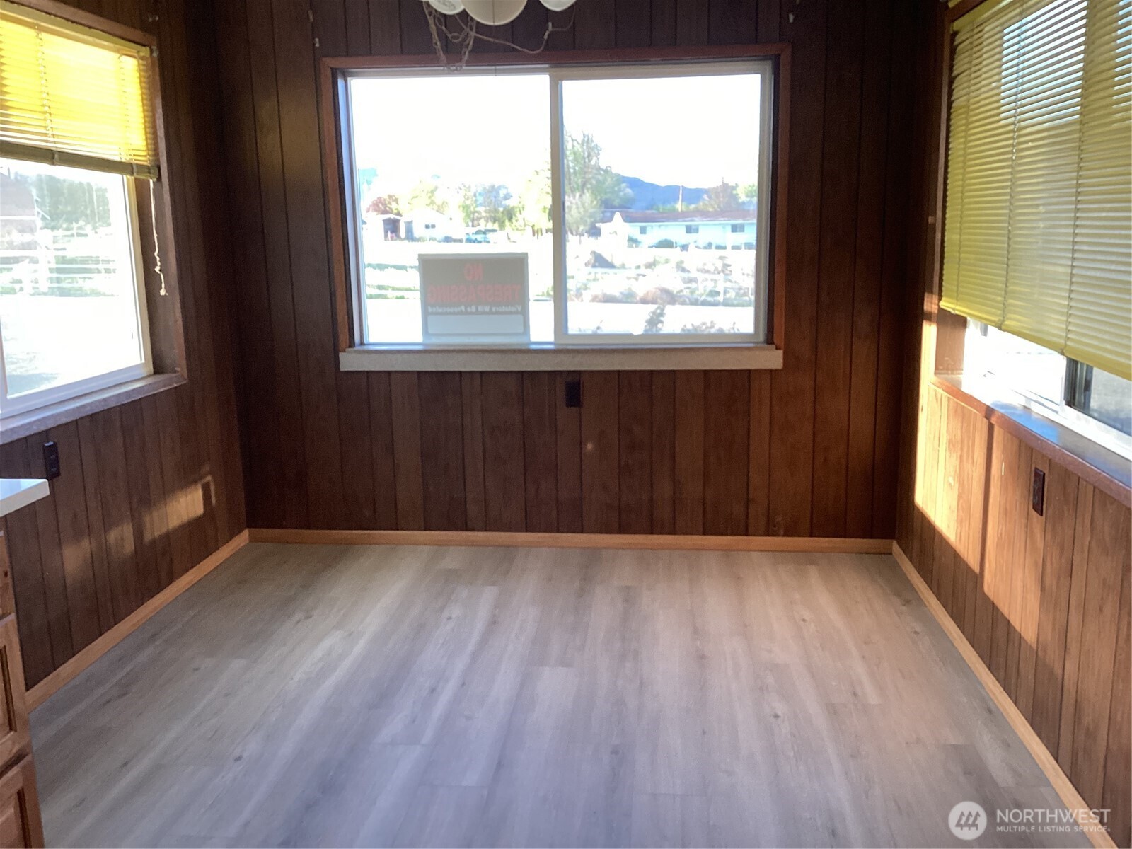 284 Monse Bridge Road Brewster, WA 98812 - Photo 8 of 11 an empty room with wooden floor and windows