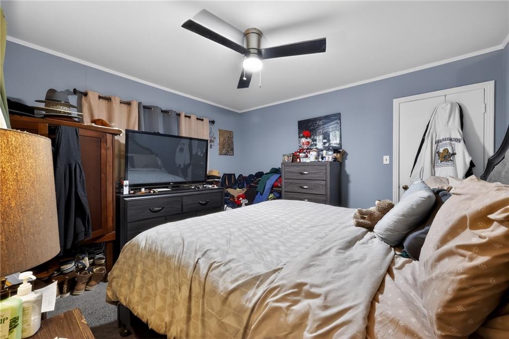 1819 Canterbury Road Macon, GA 31206 - Photo 13 of 15 a bedroom with a bed and a television