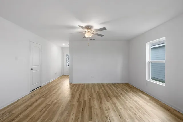 wooden floor in an empty room with a window