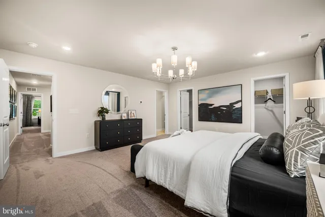 a bedroom with a bed and a chandelier