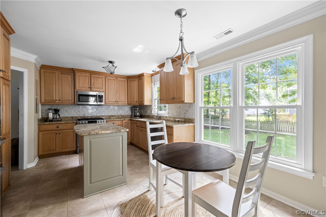 15201 Windy Ridge Road Midlothian, VA 23112 - Photo 11 of 30 a kitchen with a stove a refrigerator and chairs