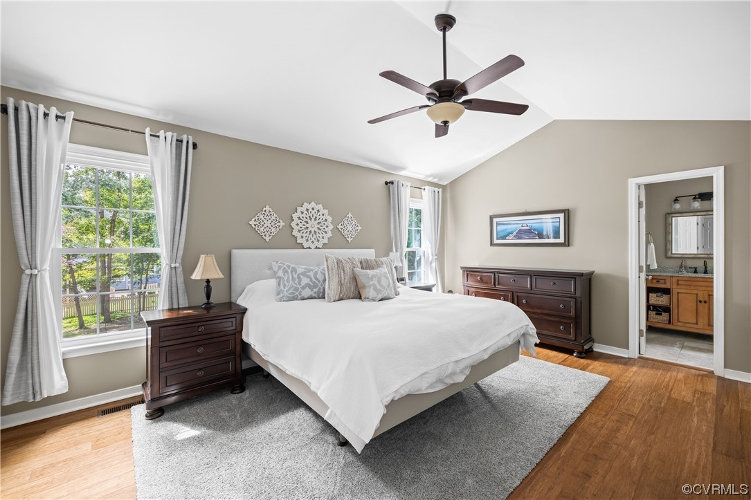 15201 Windy Ridge Road Midlothian, VA 23112 - Photo 16 of 30 a bedroom with a large bed and a chandelier