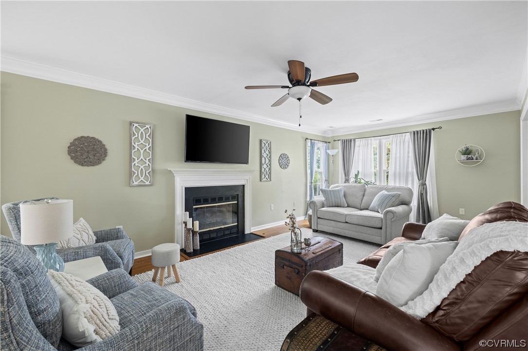 15201 Windy Ridge Road Midlothian, VA 23112 - Photo 7 of 30 a living room with furniture a fireplace and a flat screen tv