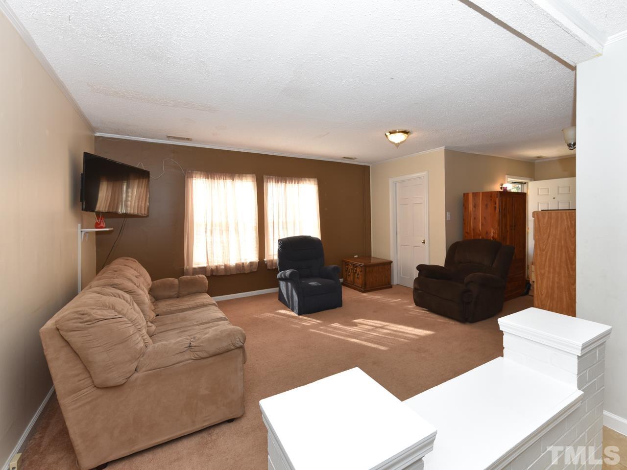 203 Smith Drive Garner, NC 27529 - Photo 5 of 13 a living room with furniture window and a flat screen tv