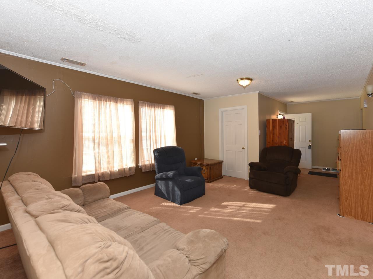 203 Smith Drive Garner, NC 27529 - Photo 6 of 13 a living room with furniture and a large window