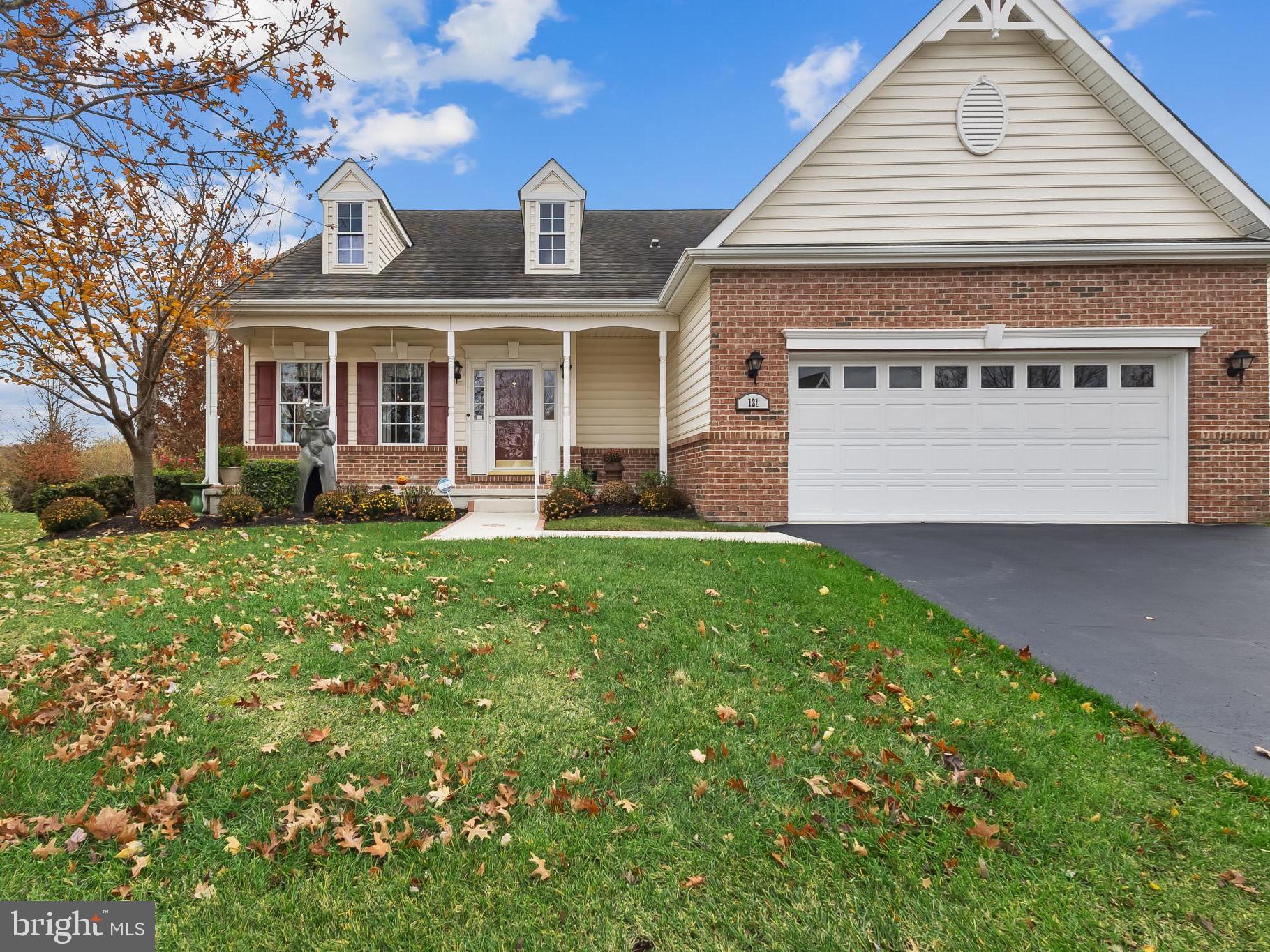 View of front of house with a porch, brick siding,