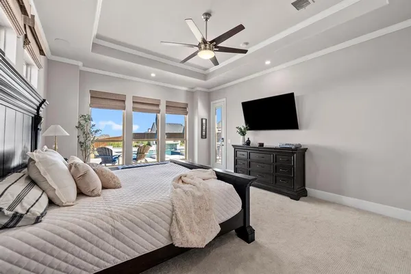 a bedroom with a bed window and a flat screen tv