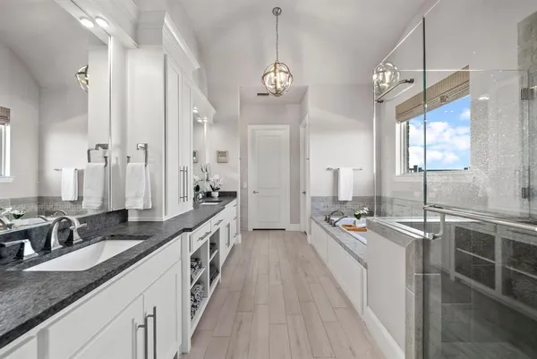 a large kitchen with kitchen island granite countertop a lot of counter space and wooden floor