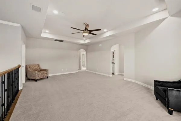 a view of an empty room with a ceiling fan