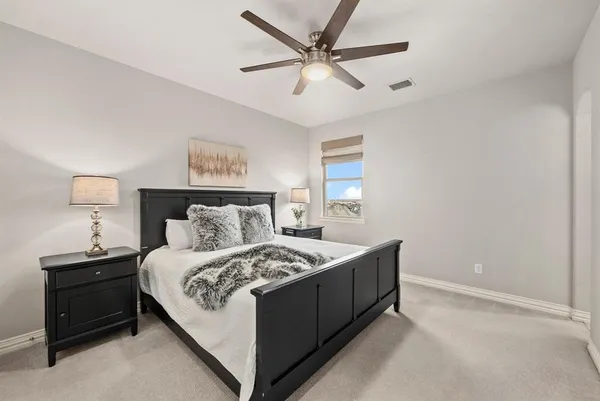 a bedroom with a bed and a night stand