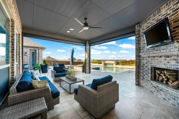 a living room with fireplace furniture and a flat screen tv