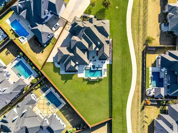 a view of a swimming pool with outdoor seating and a yard