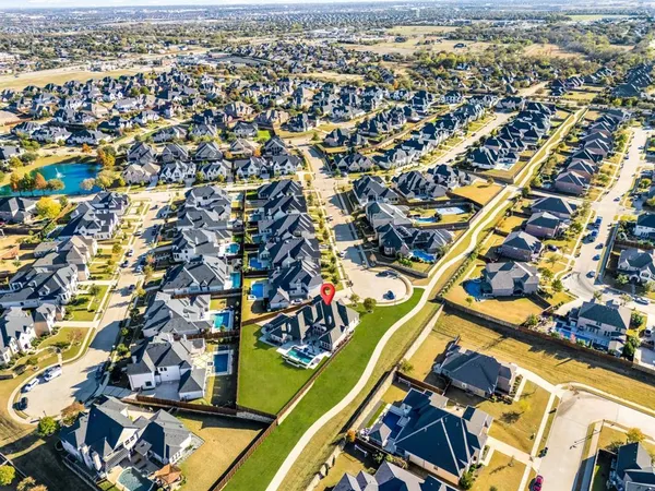 an aerial view of residential houses with city view