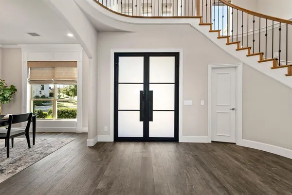 a view of entryway with wooden floor and stairs