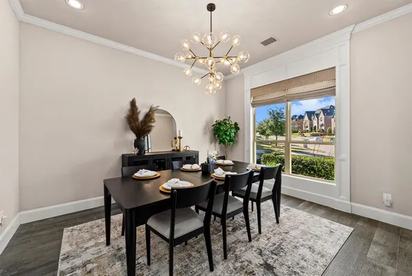 a dining room with furniture a rug and a chandelier