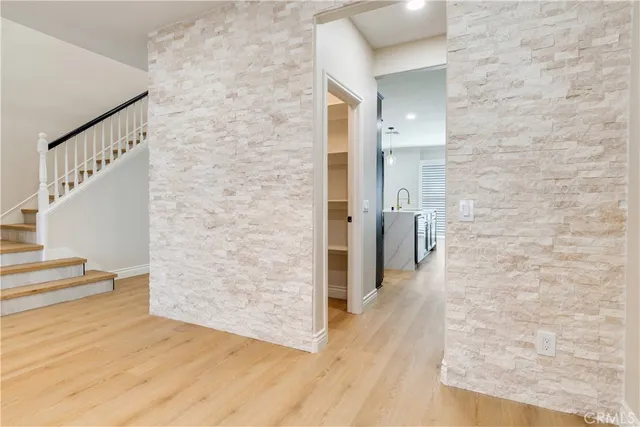 a kitchen with stainless steel appliances kitchen island granite countertop a refrigerator a stove top oven a sink and dishwasher