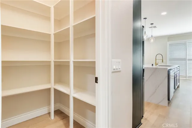 a large kitchen with stainless steel appliances granite countertop a sink a stove and a refrigerator