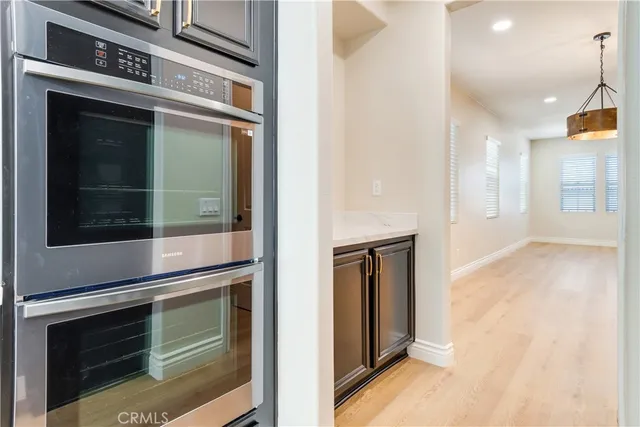 a kitchen with stainless steel appliances a sink dishwasher a stove and a refrigerator