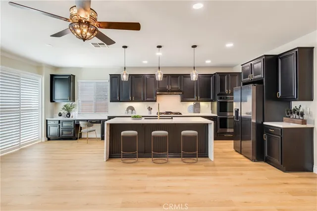 a view of an empty room with a window and a kitchen