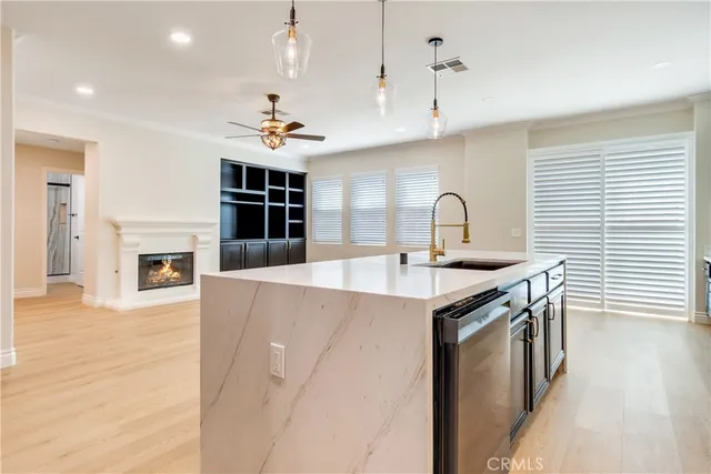 a view of an empty room with a fireplace and a window