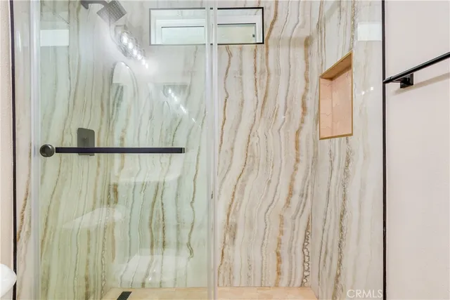 a bathroom with a double vanity sink a mirror and a shower